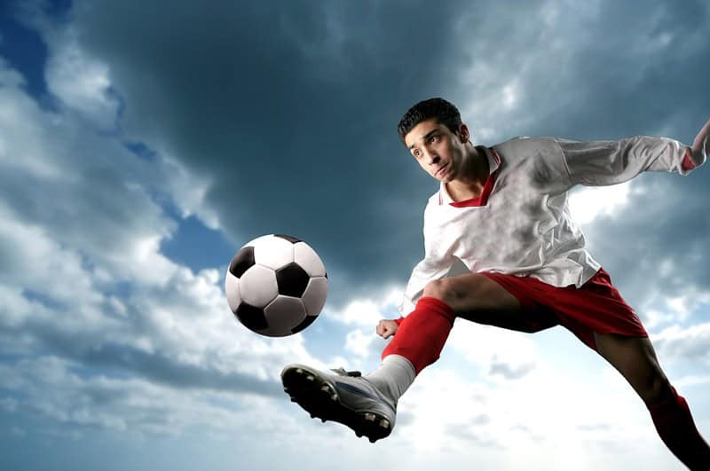 Football Player Kicking Ball